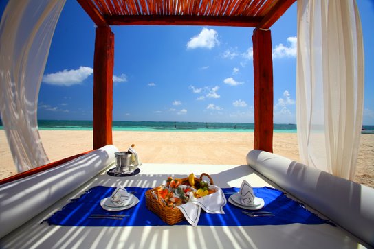 An idyllic, romantic picnic on the beach offered by the Azul Beach Hotel in Riviera Maya, Mexico