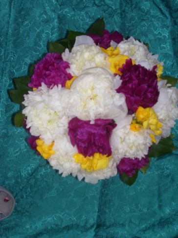 This wedding bouquet is created with white and dark pink peonies and yellow