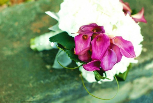 This gorgeous wedding bouquet features white flowers with purple calla 