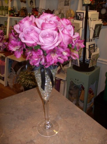 This reception centerpiece is featured in a champagne glass with beautiful 